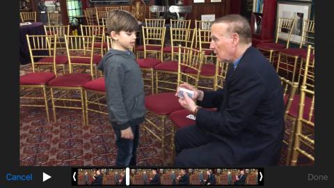 Heath talks to Magician Richard Bloch, who is sitting and holding a deck of cards