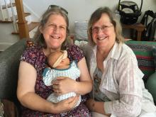 Jeane holding the new baby, with Chris sitting next to her